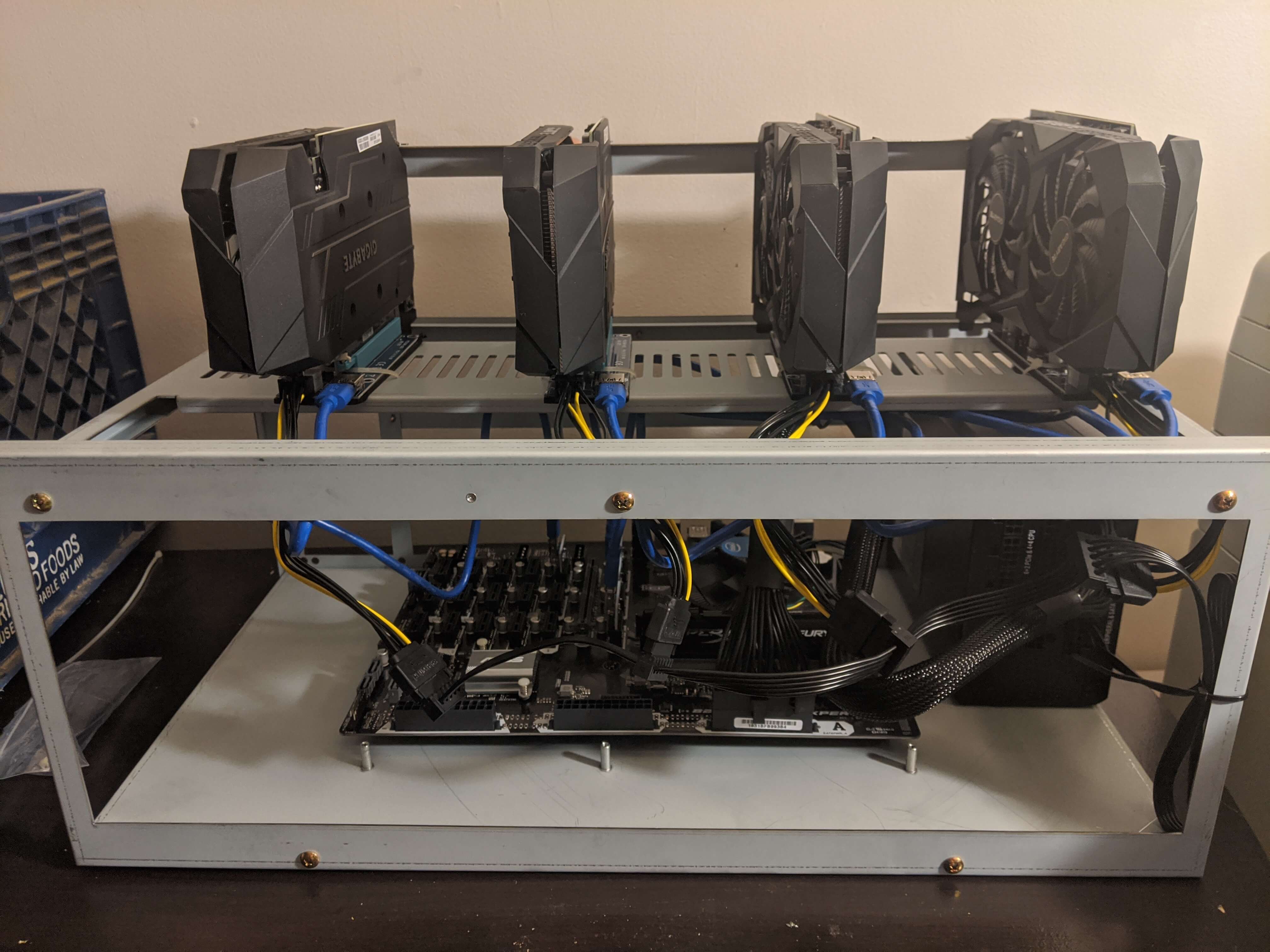 Front of rig with everything hooked up and GPUs added on top rack.